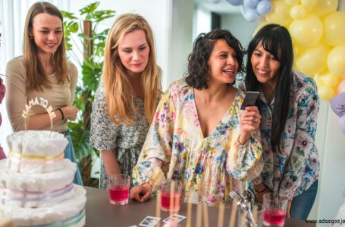 Guests laughing and enjoying fun baby shower games during a celebration