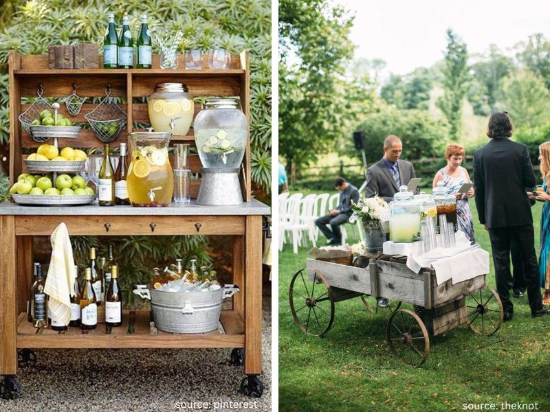 Rustic backyard wedding bar cart decorated with flowers, drinks, candles, and handwritten signage.