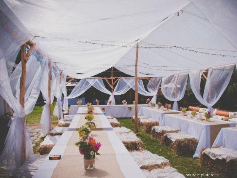 Elegant outdoor wedding decor secured against wind showing practical and beautiful setup.