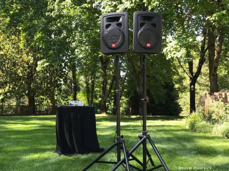 Outdoor wedding ceremony microphone and speaker system ensuring clear sound for guests.