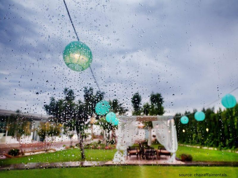 Outdoor wedding tent setup ready as a backup plan for unexpected rain during ceremony.