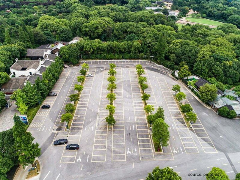 Outdoor wedding parking area with signs and organized guest vehicle arrangement.