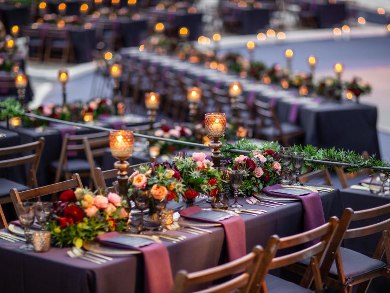 Romantic candlelit wedding table decor with pillar candles and soft lighting for an intimate budget wedding.