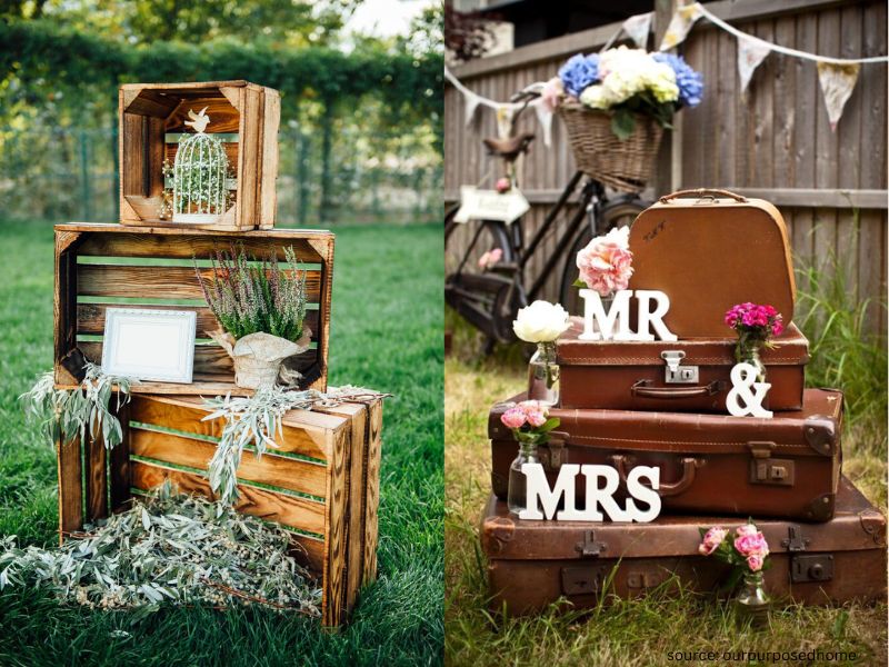 Upcycled wedding decor using wooden crates and vintage suitcases for stylish budget wedding styling.