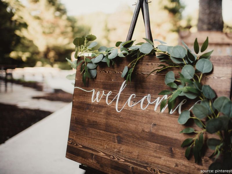 Elegant wedding welcome sign with floral decor at ceremony entrance