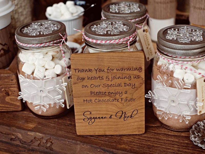 Hot chocolate wedding favor jars layered with cocoa, marshmallows, and chocolate chips
