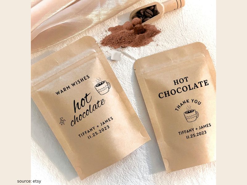 Hot chocolate wedding favor jars layered with cocoa, marshmallows, and chocolate chips