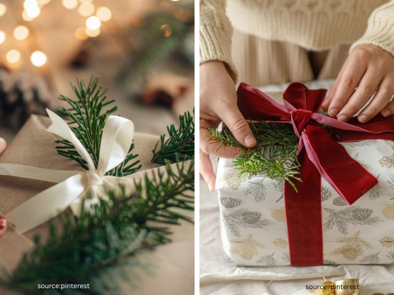 Christmas gift wrapped in kraft paper with a small sprig of greenery tucked beneath the ribbon
