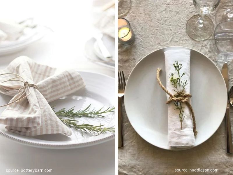 Beige linen napkin folded on a white dinner plate with a sprig of rosemary