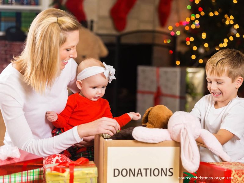 Family donating Christmas gifts and toys as part of a giving tradition